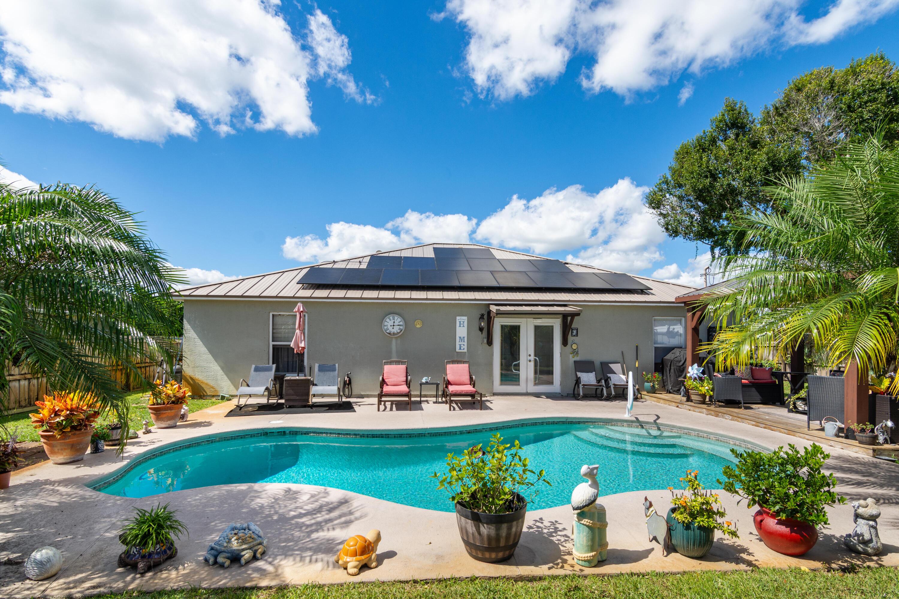 1817 Southwest Davis Street Port St. Lucie, FL 34953 - Photo 37 of 52 a view of a house with outdoor space and swimming pool