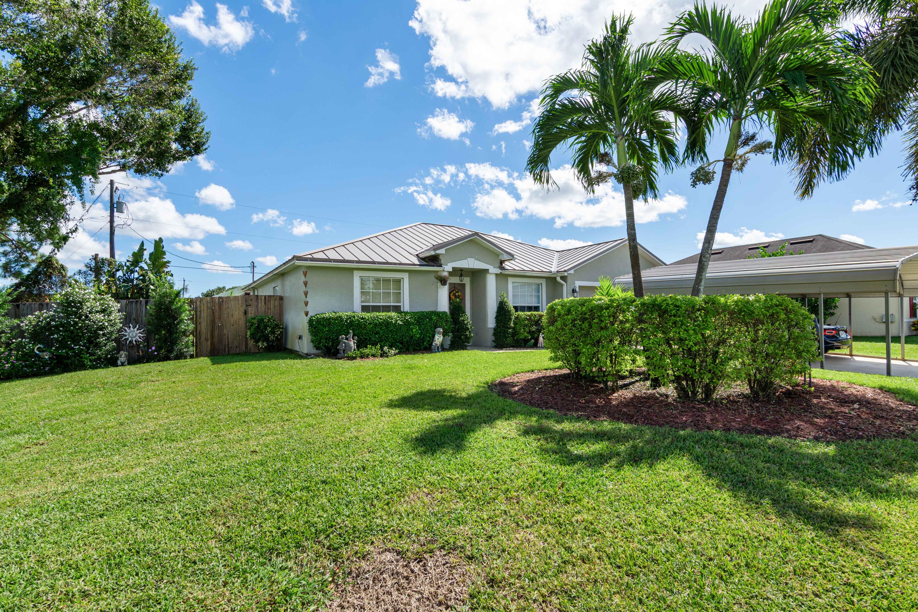 1817 Southwest Davis Street Port St. Lucie, FL 34953 - Photo 4 of 52 a front view of a house with garden