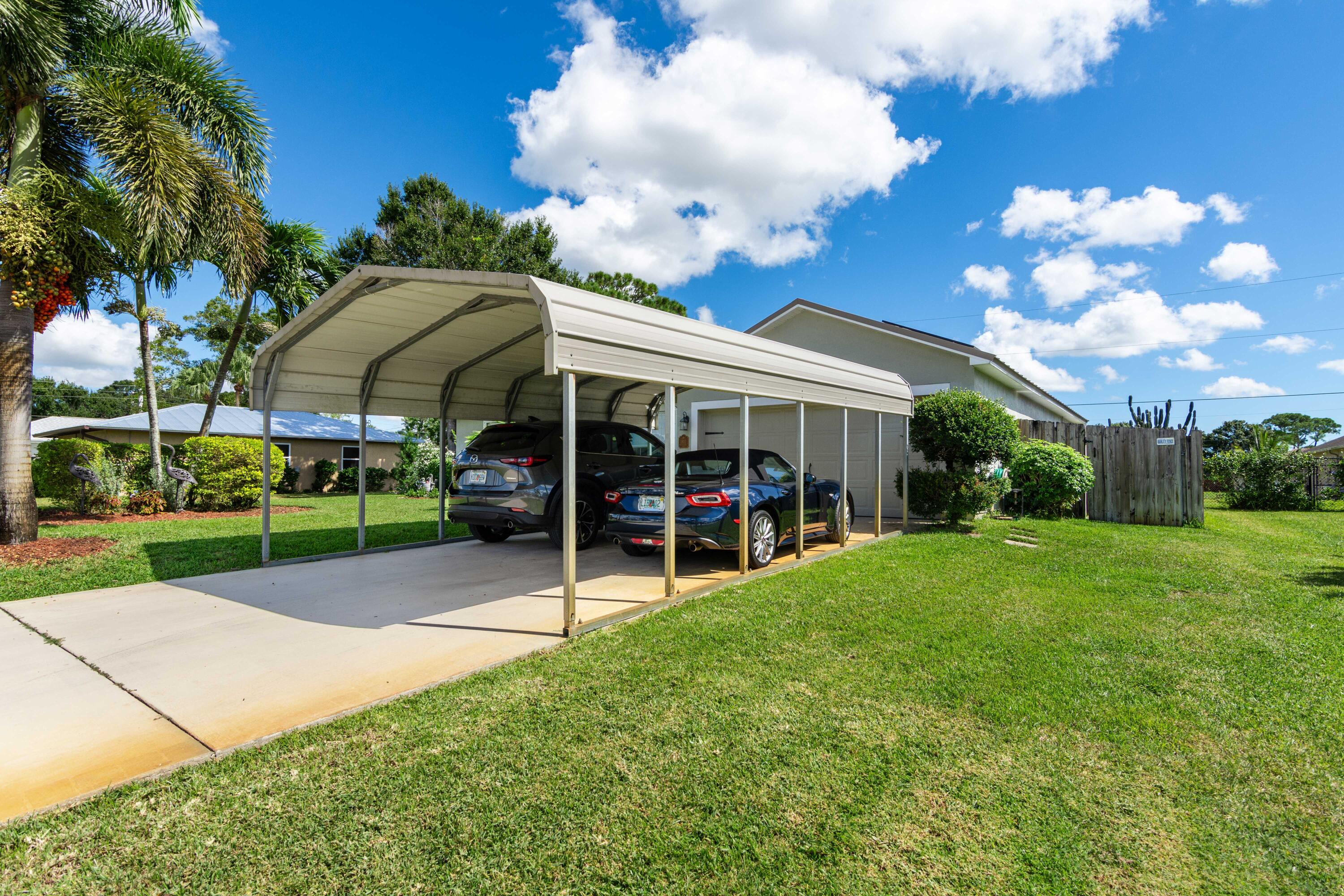 1817 Southwest Davis Street Port St. Lucie, FL 34953 - Photo 5 of 52 a view of a house with a big yard and large trees