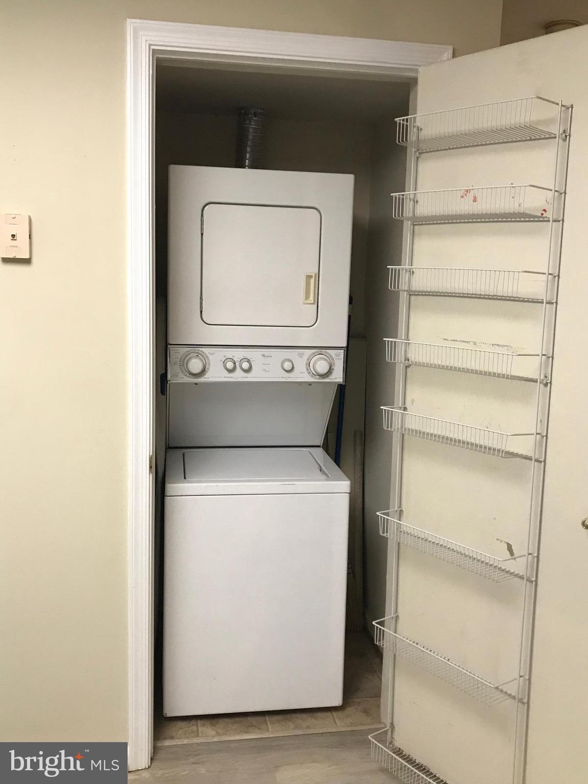 10712 Kings Riding Way, Unit T115 Rockville, MD 20852 - Photo 20 of 27 Stacked washer & dryer in kitchen.