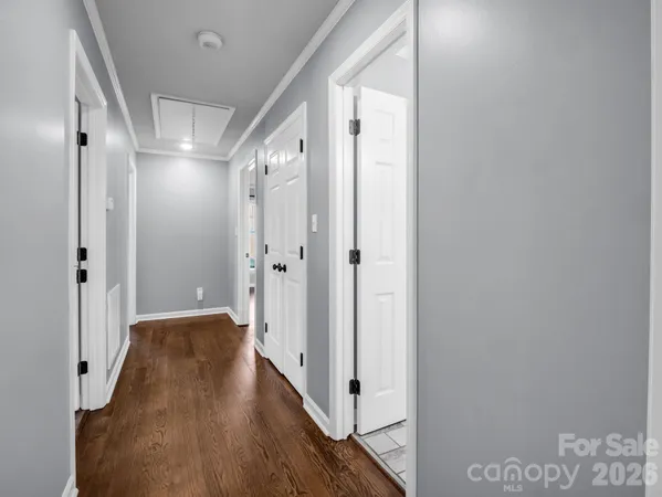a view of a hallway with wooden floor