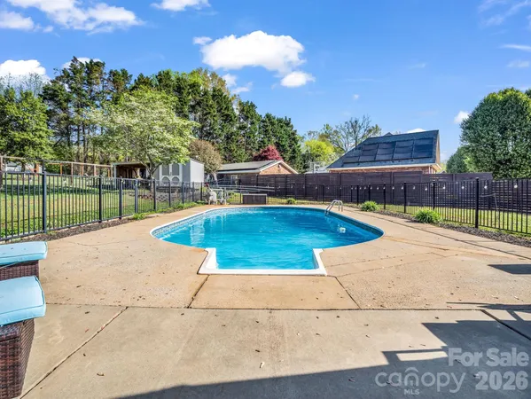 a view of a swimming pool with a lounge chairs