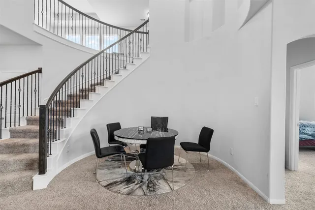 a kitchen with stainless steel appliances granite countertop a refrigerator a sink a stove top oven and a refrigerator