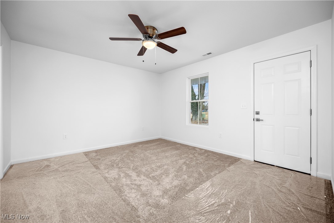 1996 East Oldgate Road Sandusky, OH 44870 - Photo 19 of 38 Empty room featuring light carpet and ceiling fan. Master Builder Interior Photo