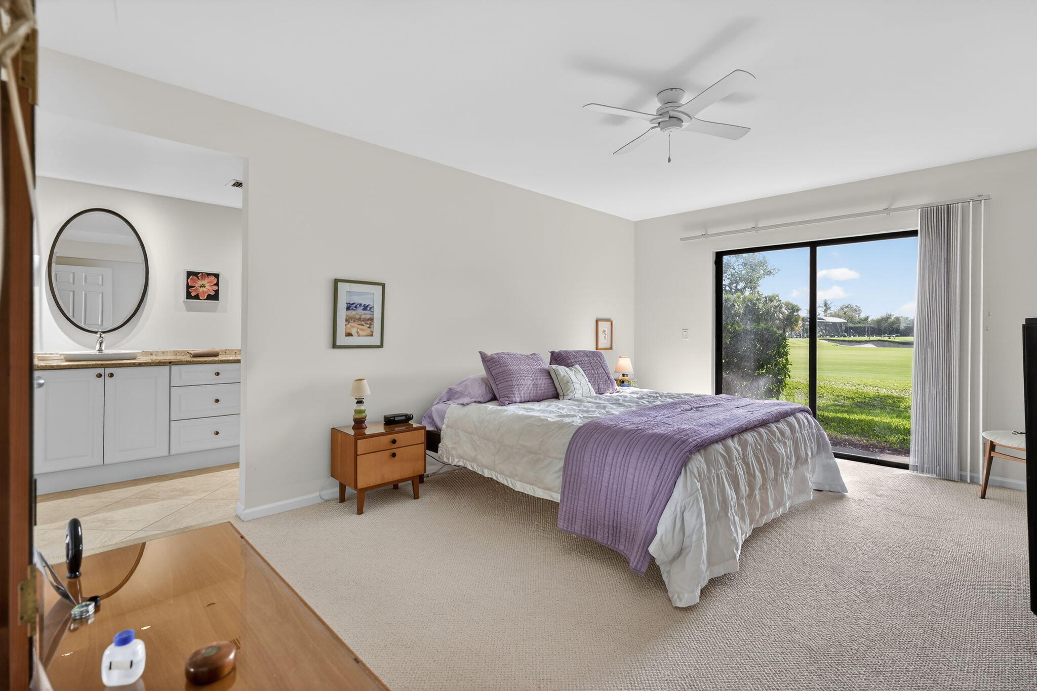 16670 Traders Crossing North, Unit 110 Jupiter, FL 33477 - Photo 12 of 22 a spacious bedroom with a bed and a large window