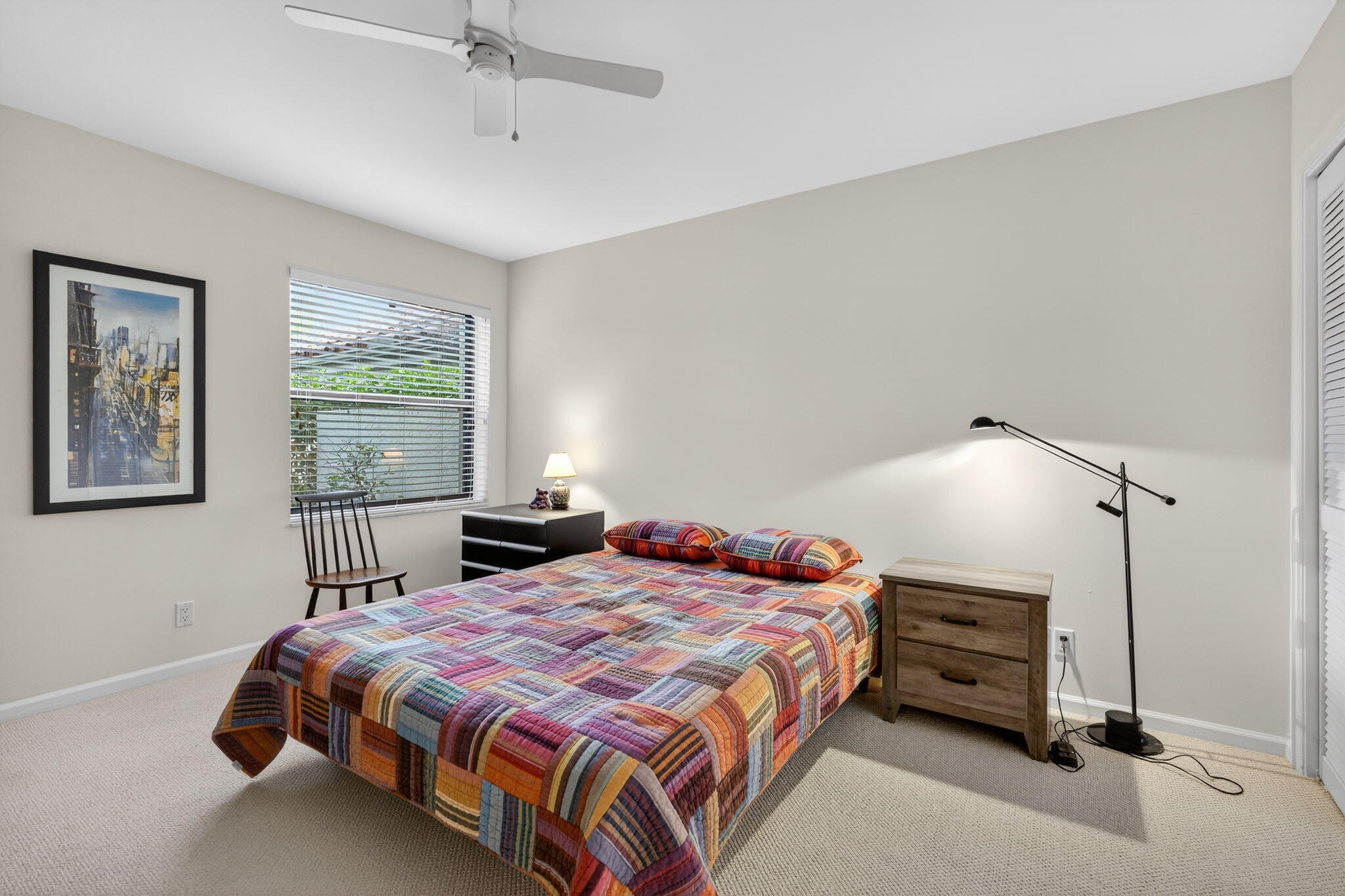 16670 Traders Crossing North, Unit 110 Jupiter, FL 33477 - Photo 15 of 22 a bedroom with a bed and window