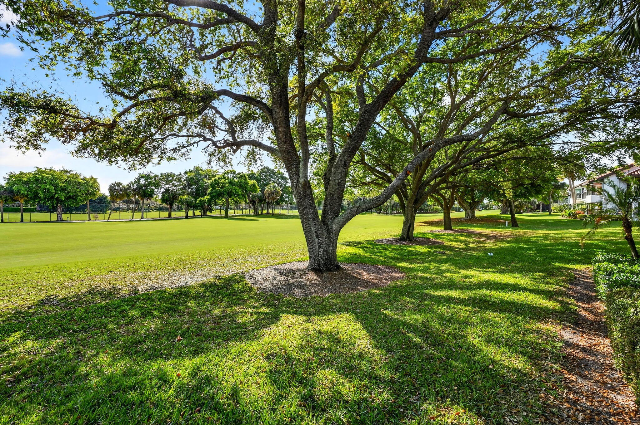16670 Traders Crossing North, Unit 110 Jupiter, FL 33477 - Photo 18 of 22 a view of a grassy field with sitting area