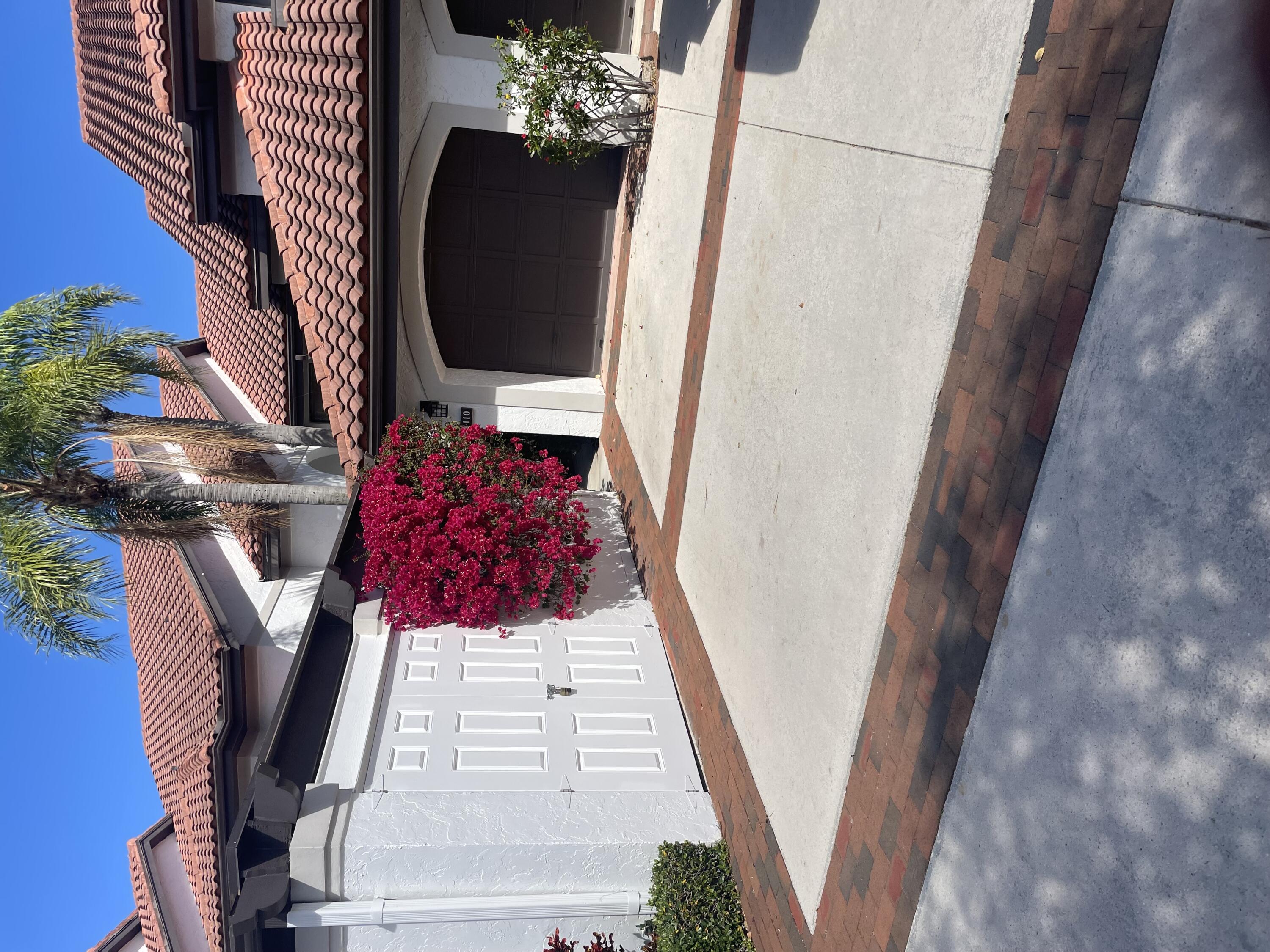 16670 Traders Crossing North, Unit 110 Jupiter, FL 33477 - Photo 22 of 22 a front view of a house with garage