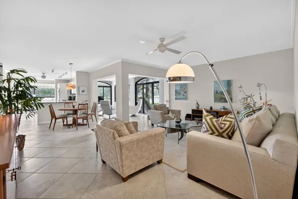 a living room with furniture and a chandelier