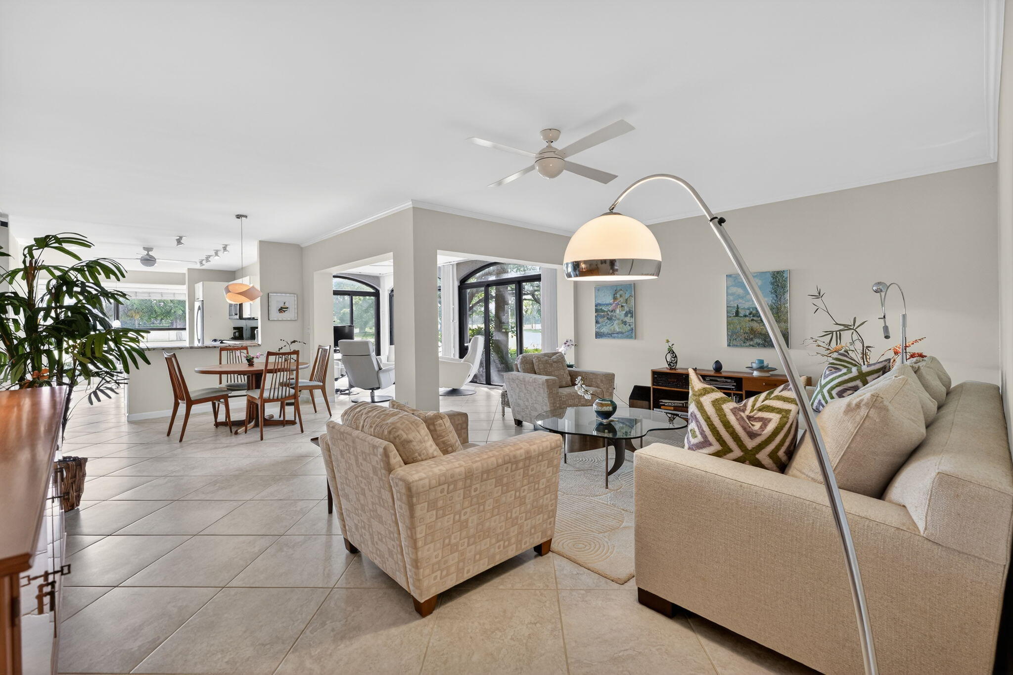 16670 Traders Crossing North, Unit 110 Jupiter, FL 33477 - Photo 4 of 22 a living room with furniture and a chandelier