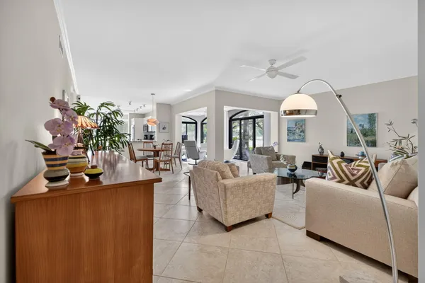 a living room with fireplace furniture and a potted plant