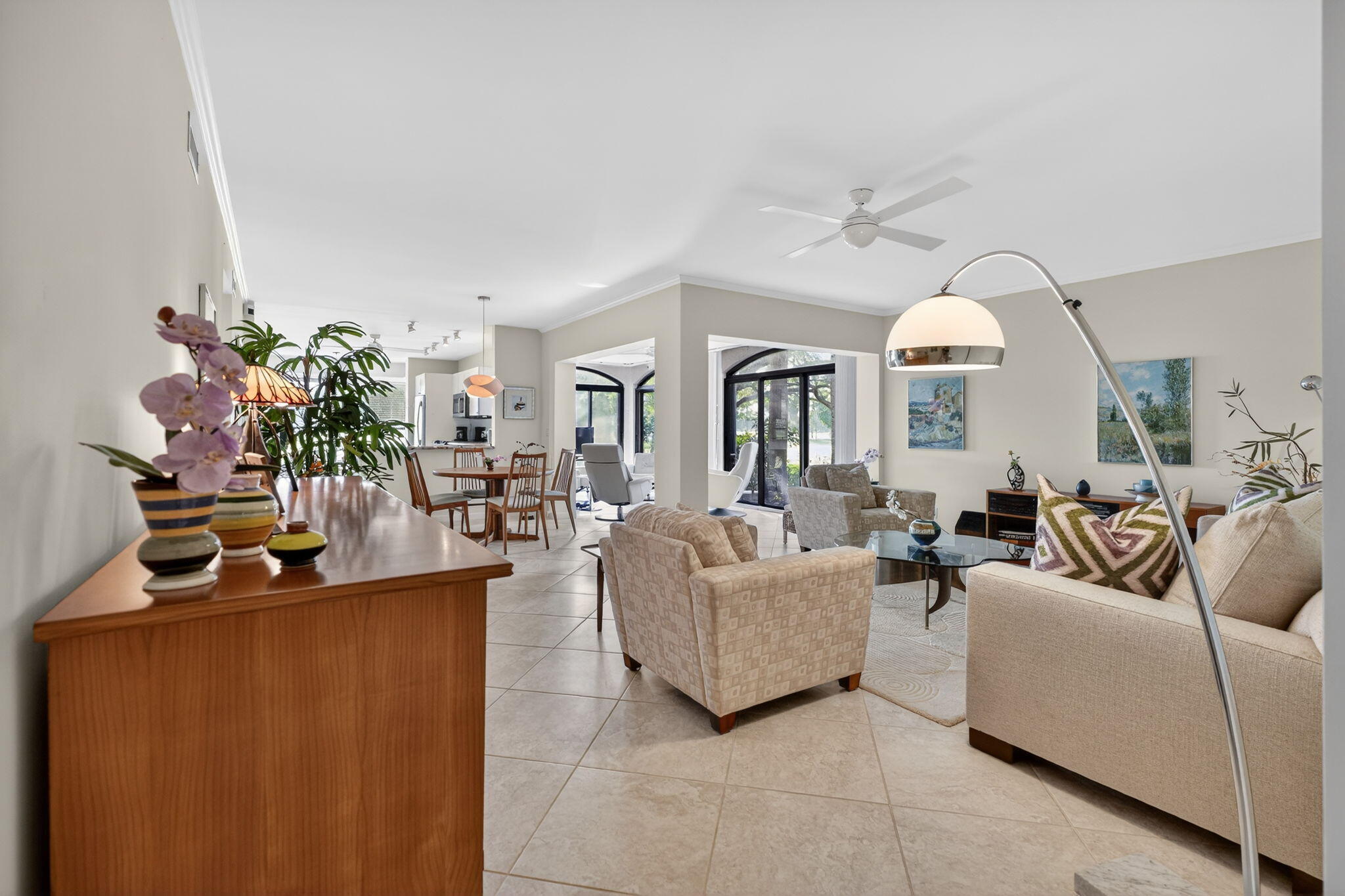 16670 Traders Crossing North, Unit 110 Jupiter, FL 33477 - Photo 5 of 22 a living room with fireplace furniture and a potted plant