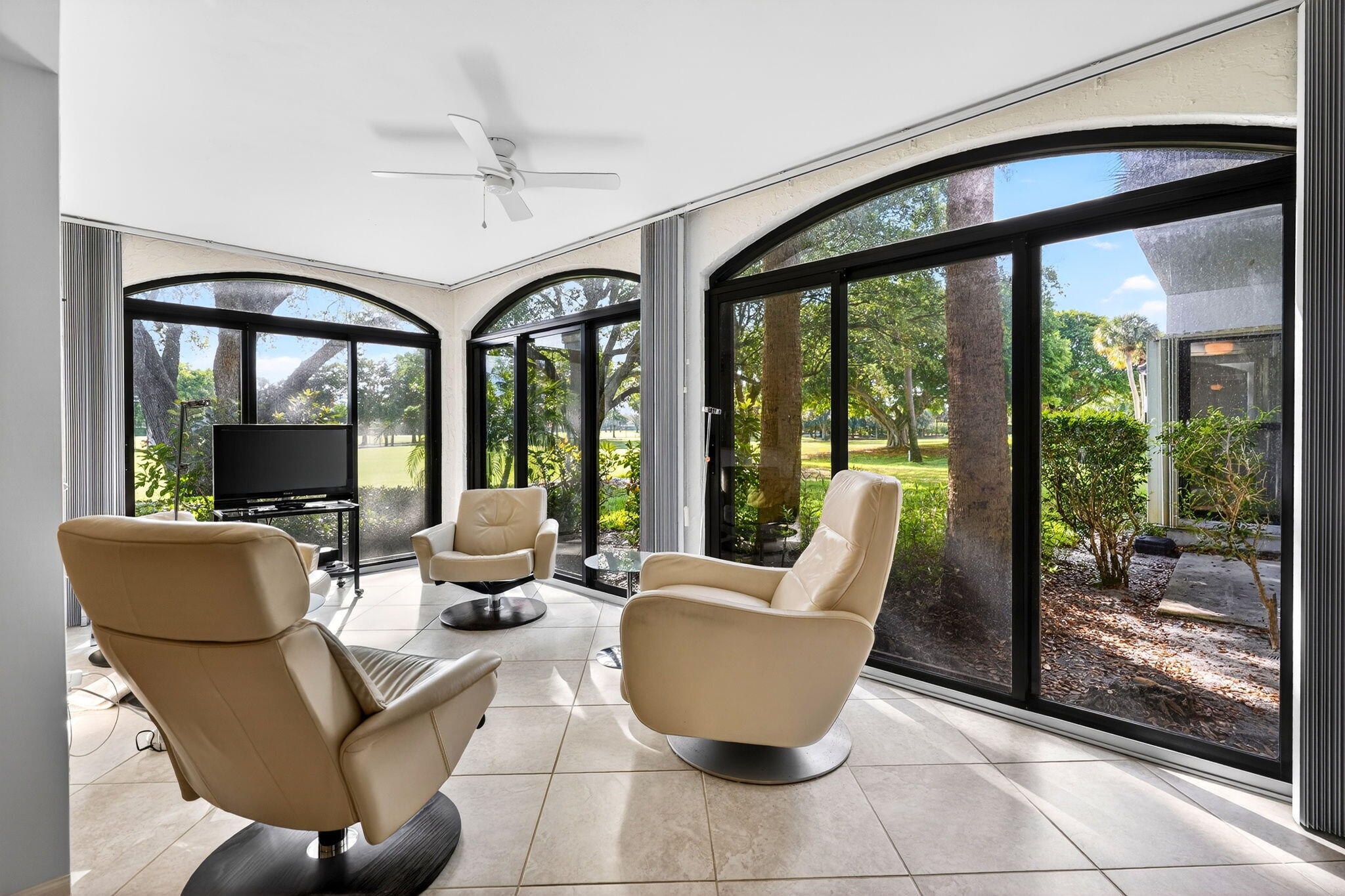 16670 Traders Crossing North, Unit 110 Jupiter, FL 33477 - Photo 9 of 22 a living room with furniture and a large window