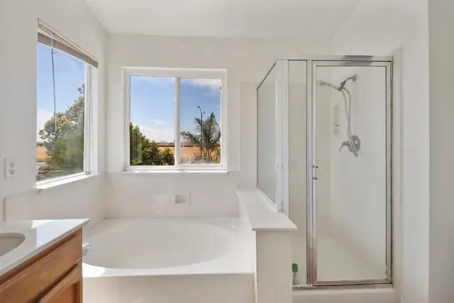 a white bath tub with a shower