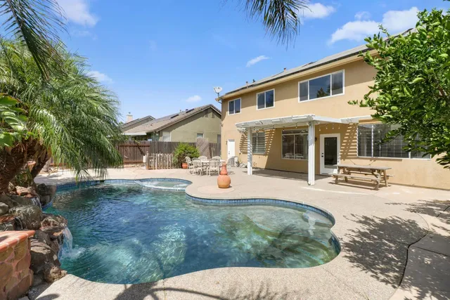 a view of a house with backyard porch and sitting area