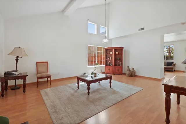 a living room with furniture a rug and a lamp