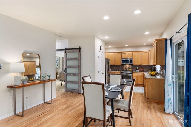 a view of a dining room with furniture and wooden floor