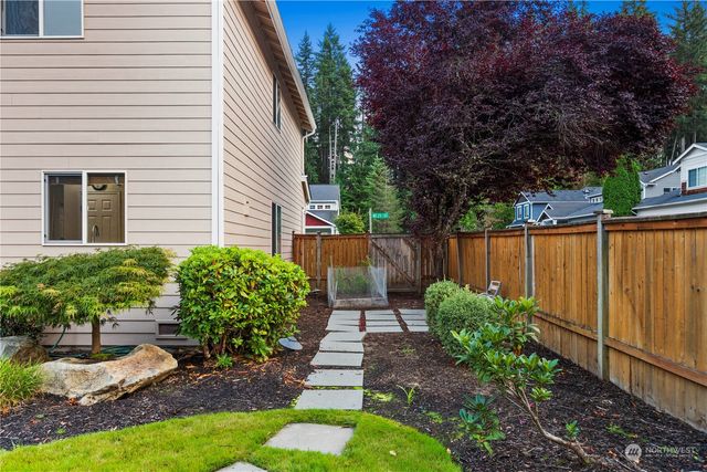 a view of a house with backyard sitting area and garden