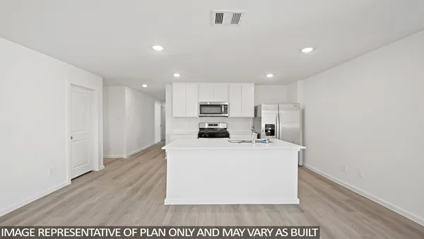 a living room with stainless steel appliances kitchen island a stove a refrigerator and a stove
