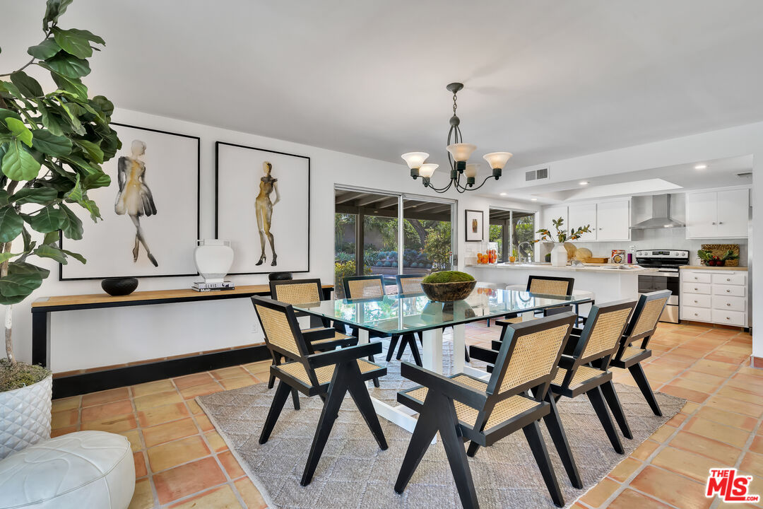 73589 Haystack Road Palm Desert, CA 92260 - Photo 11 of 54 a view of a dining room with furniture and chandelier