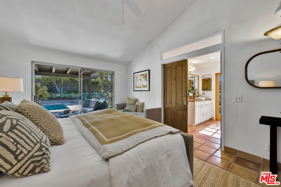 73589 Haystack Road Palm Desert, CA 92260 - Photo 18 of 54 a living room with a bed and glass windows