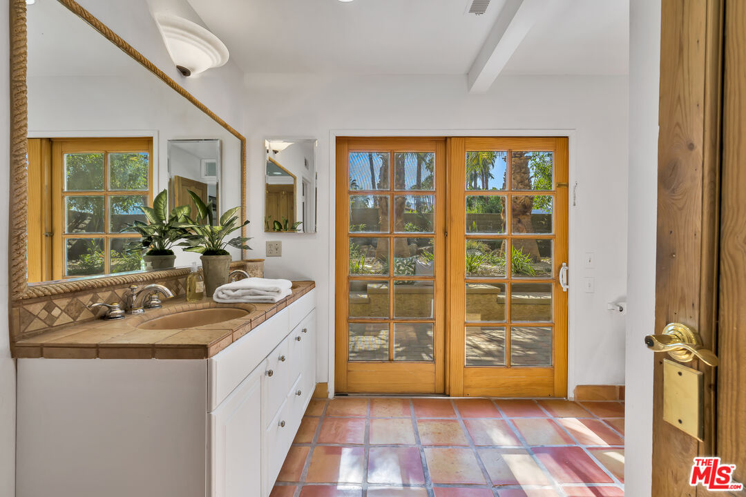 73589 Haystack Road Palm Desert, CA 92260 - Photo 19 of 54 a bathroom with a granite countertop sink and a mirror