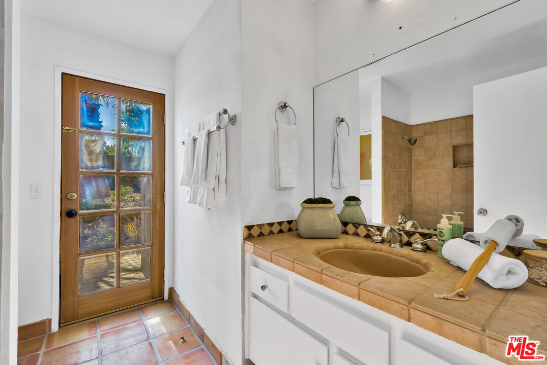 73589 Haystack Road Palm Desert, CA 92260 - Photo 23 of 54 a bathroom with a sink double vanity and a mirror