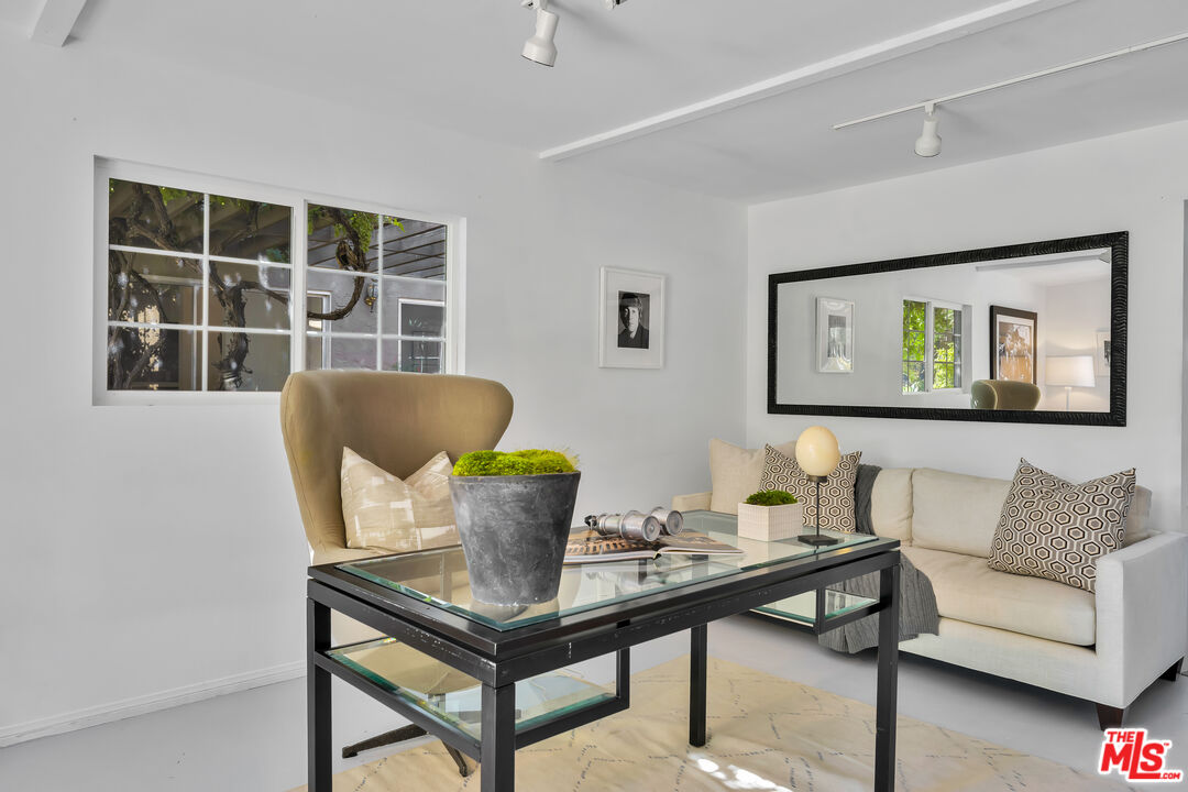 73589 Haystack Road Palm Desert, CA 92260 - Photo 27 of 54 a living room with furniture a window and a potted plant