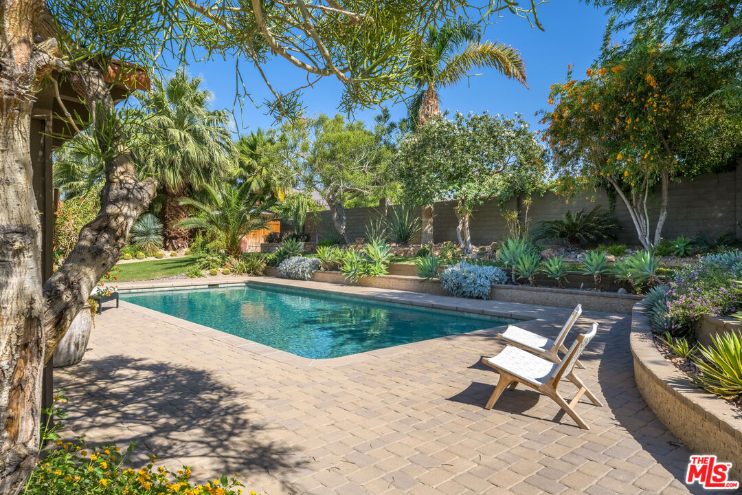 73589 Haystack Road Palm Desert, CA 92260 - Photo 30 of 54 a view of a swimming pool with lounge chair