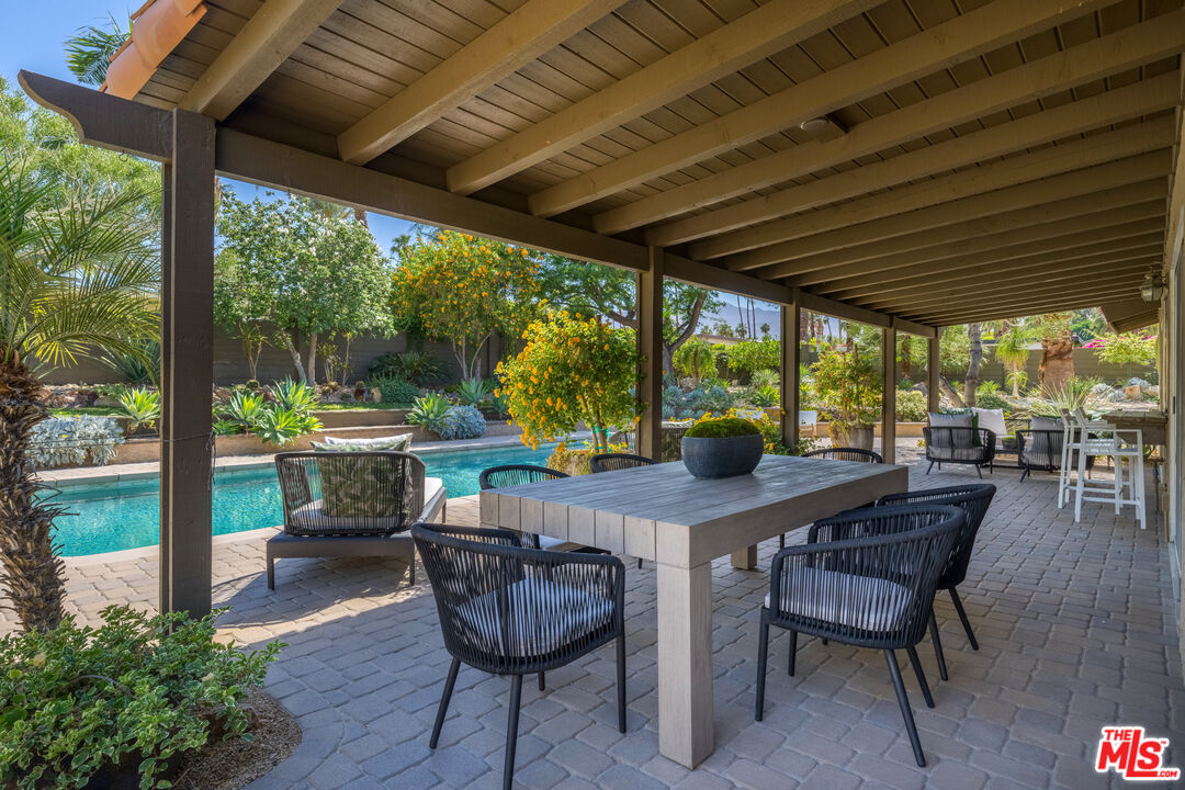 73589 Haystack Road Palm Desert, CA 92260 - Photo 31 of 54 a view of a patio with a table chairs and a backyard
