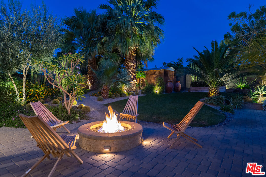 73589 Haystack Road Palm Desert, CA 92260 - Photo 49 of 54 a view of a backyard with table and chairs potted plants and palm tree