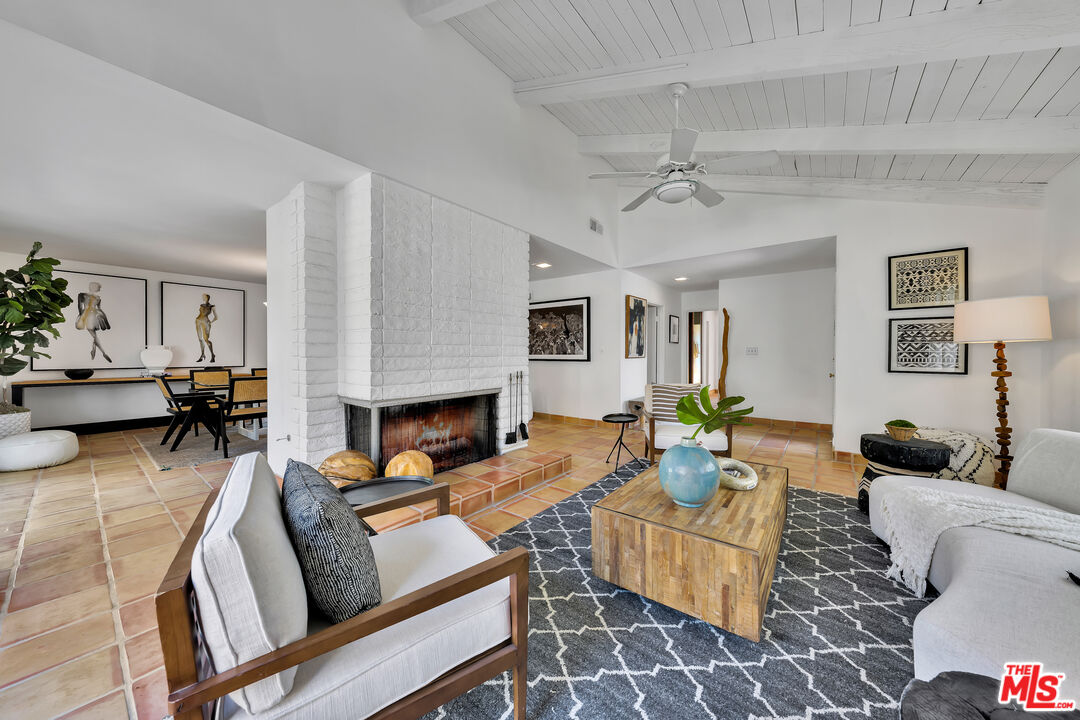 73589 Haystack Road Palm Desert, CA 92260 - Photo 6 of 54 a living room with furniture a fireplace and a table