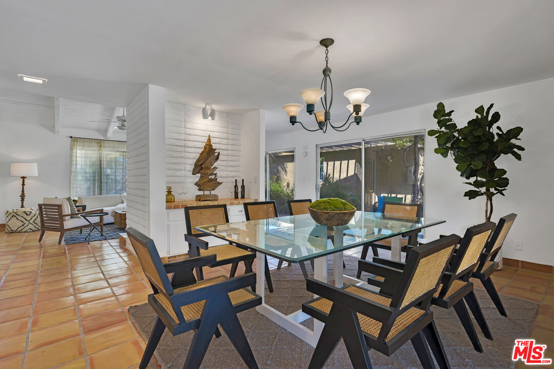 73589 Haystack Road Palm Desert, CA 92260 - Photo 9 of 54 a view of a dining room with furniture wooden floor and chandelier