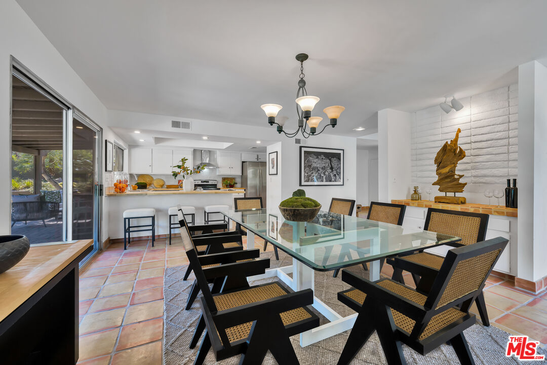 73589 Haystack Road Palm Desert, CA 92260 - Photo 10 of 54 a view of a dining room with furniture and wooden floor