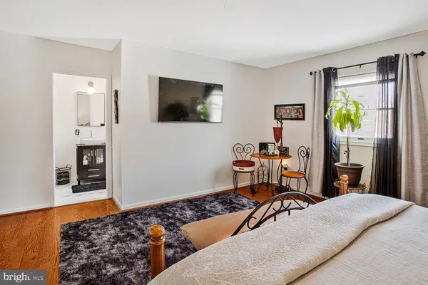 a bedroom with a bed and the view of kitchen