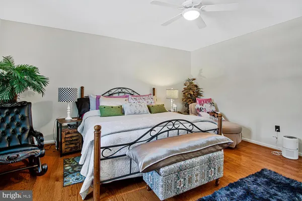 a bedroom with furniture and a wooden floor