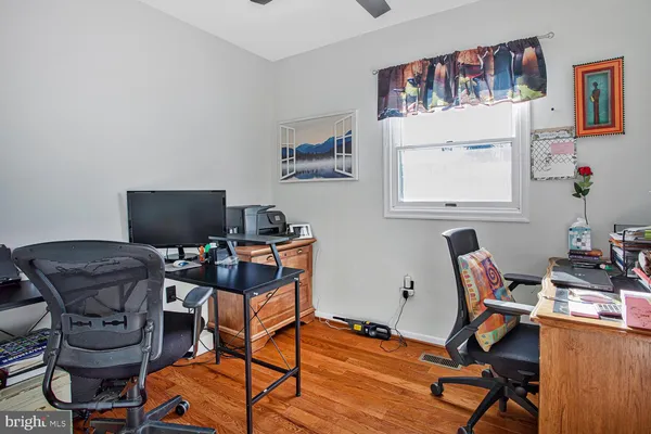 a workspace with furniture and wooden floor