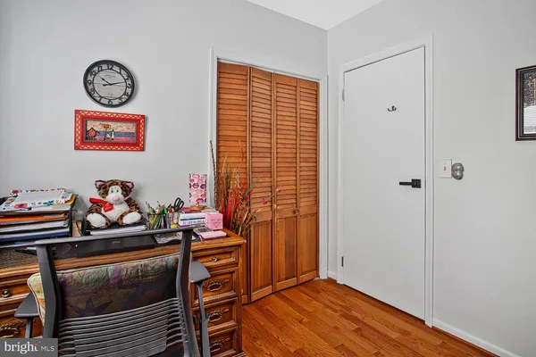 a view of a room with workspace and wooden floor