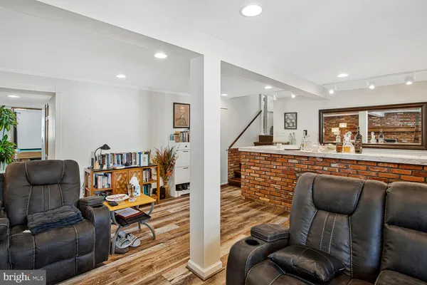 a living room with furniture and wooden floor