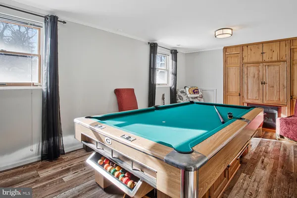 a room with pool table and windows
