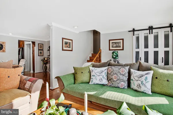 a living room with furniture and painting on the wall