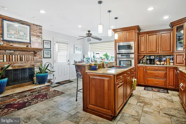 a kitchen with stainless steel appliances granite countertop a stove a sink and a refrigerator