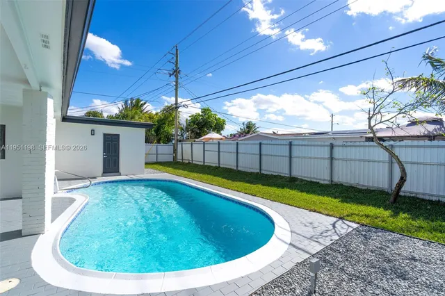 a view of a backyard with swimming pool