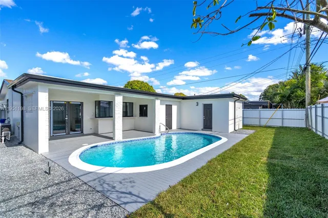 a view of a house with backyard porch and sitting area