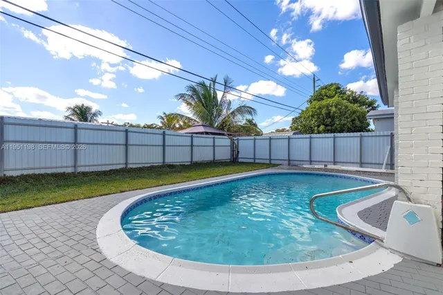 a view of a swimming pool with a yard
