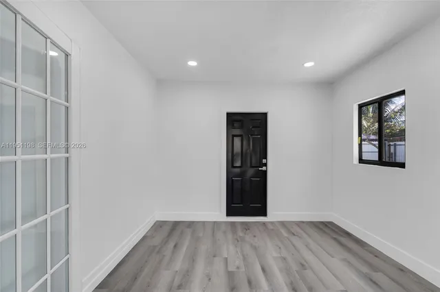 wooden floor in an empty room with a window