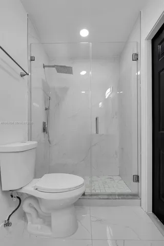 a bathroom with a toilet and a shower