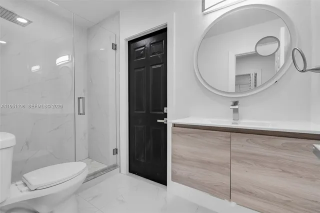 a bathroom with a toilet a sink and a mirror