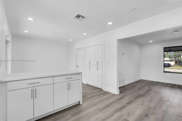 a view of a kitchen with wooden floors