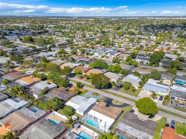 an aerial view of residential houses with outdoor space